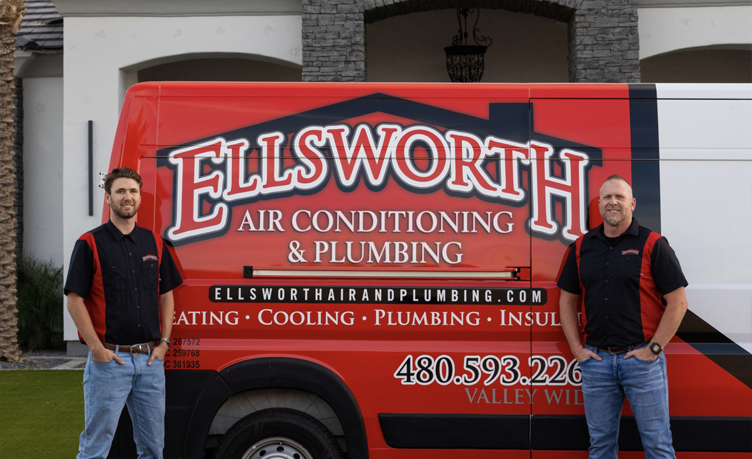 Two workers standing by a red Ellsworth Air Conditioning and Plumbing van, showcasing company services.