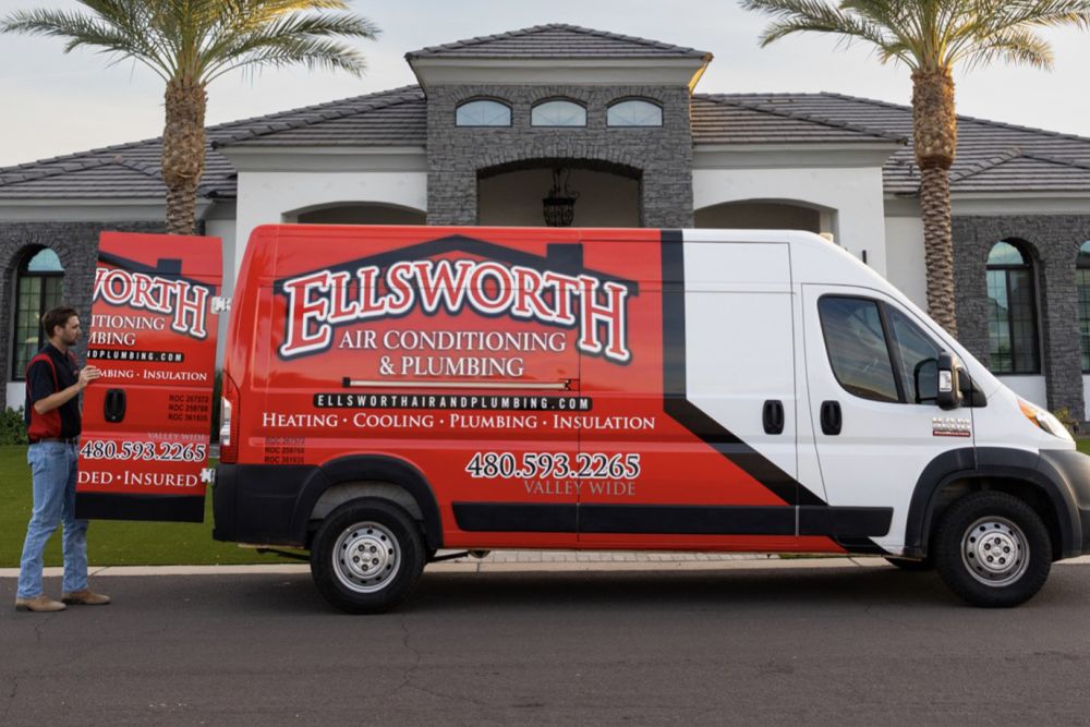 Red Ellsworth Air Conditioning & Plumbing van parked in front of a modern house with palm trees.