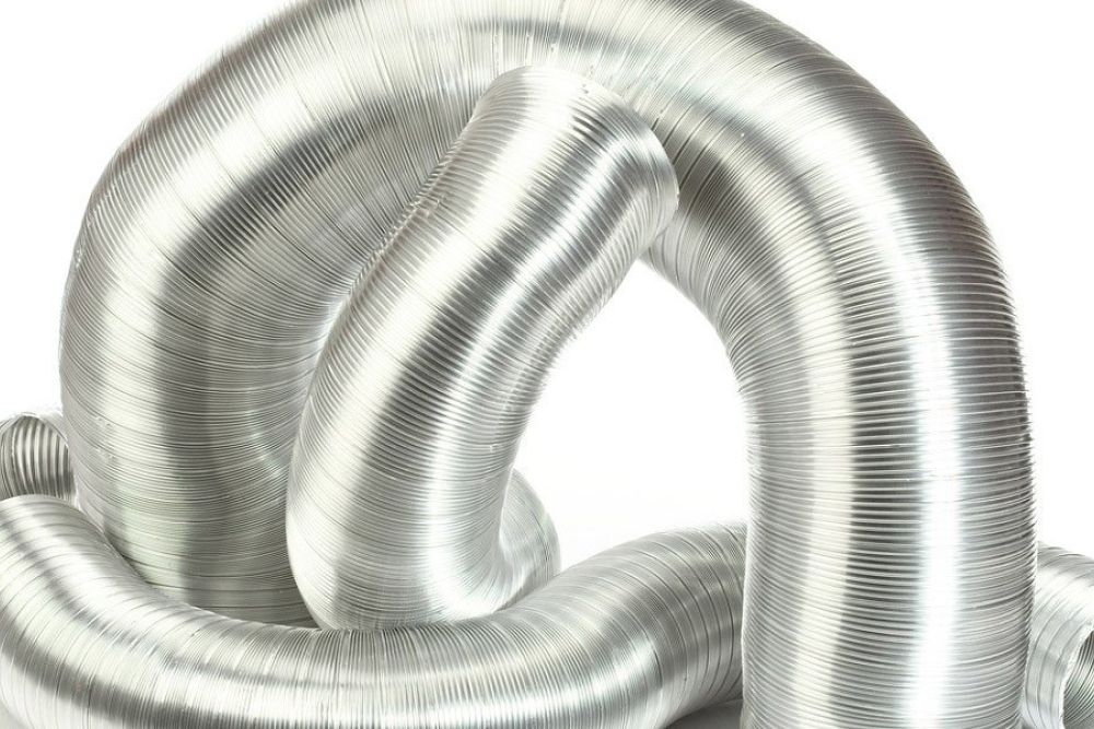 Shiny metal coil duct in abstract shape, ideal for HVAC systems and flexible ventilation solutions.