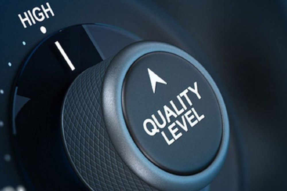 Close-up of a dial set to high with text Quality Level, signifying superior performance or excellence.