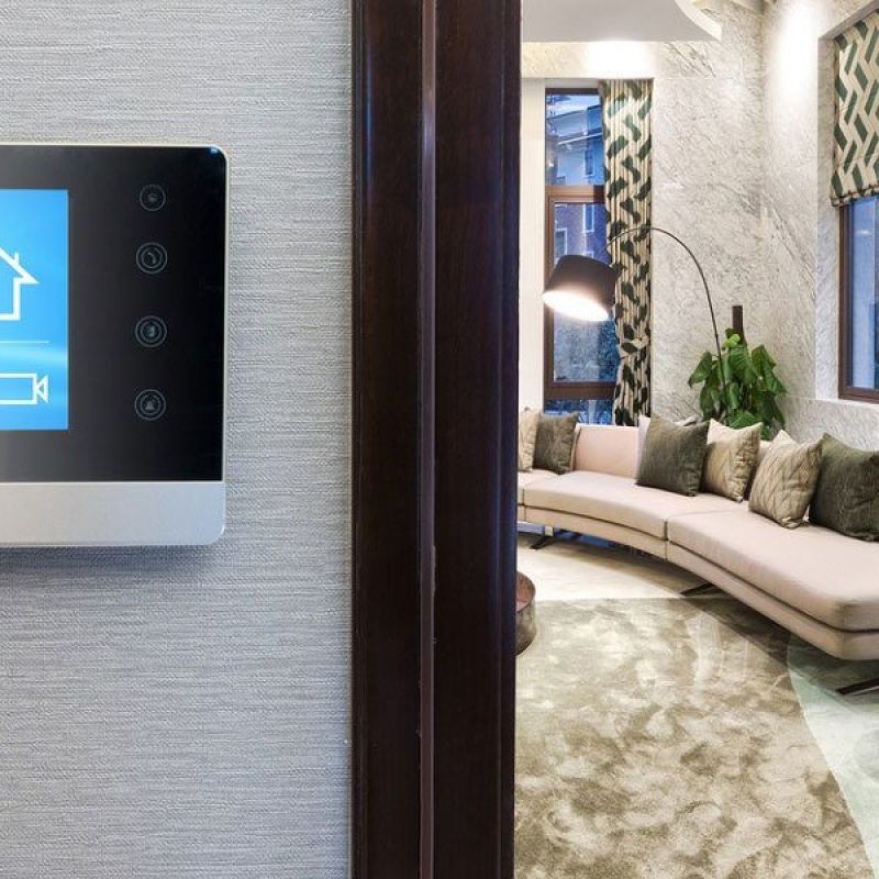 Smart home display showing temperature and settings in a modern, elegantly designed living room.