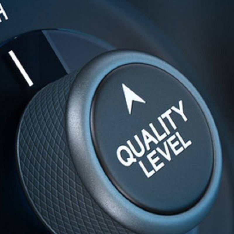 Close-up of a dial set to high with text Quality Level, signifying superior performance or excellence.
