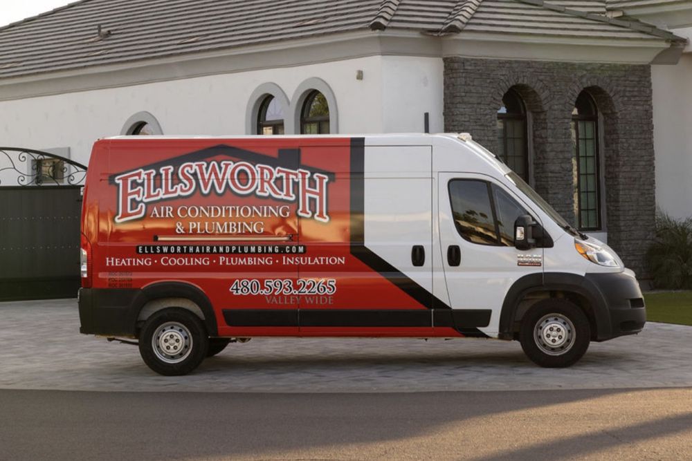 Ellsworth Air Conditioning & Plumbing service van parked, featuring company logo and contact information.