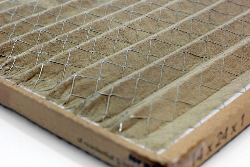 Close-up of a pleated HVAC air filter showing its intricate mesh pattern for improved indoor air quality.