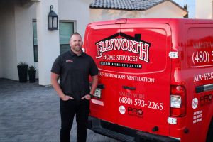Man standing by Ellsworth Air Conditioning & Plumbing  van, offering heating, insulation, and ventilation services.